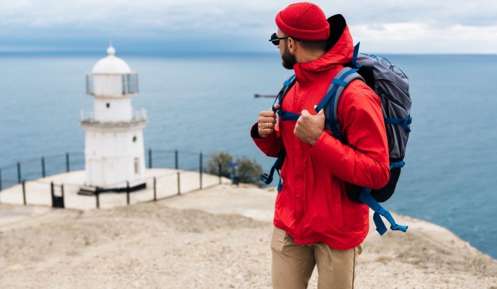 backpacker looking back at the lighthouse - ee220330