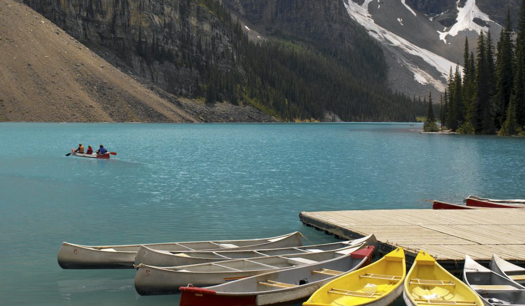 different boat colors park on side of lake louise 
