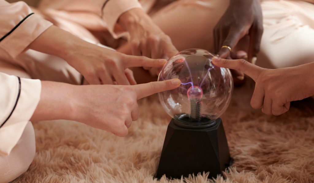 group of friend touching crystal ball paranormal activity 