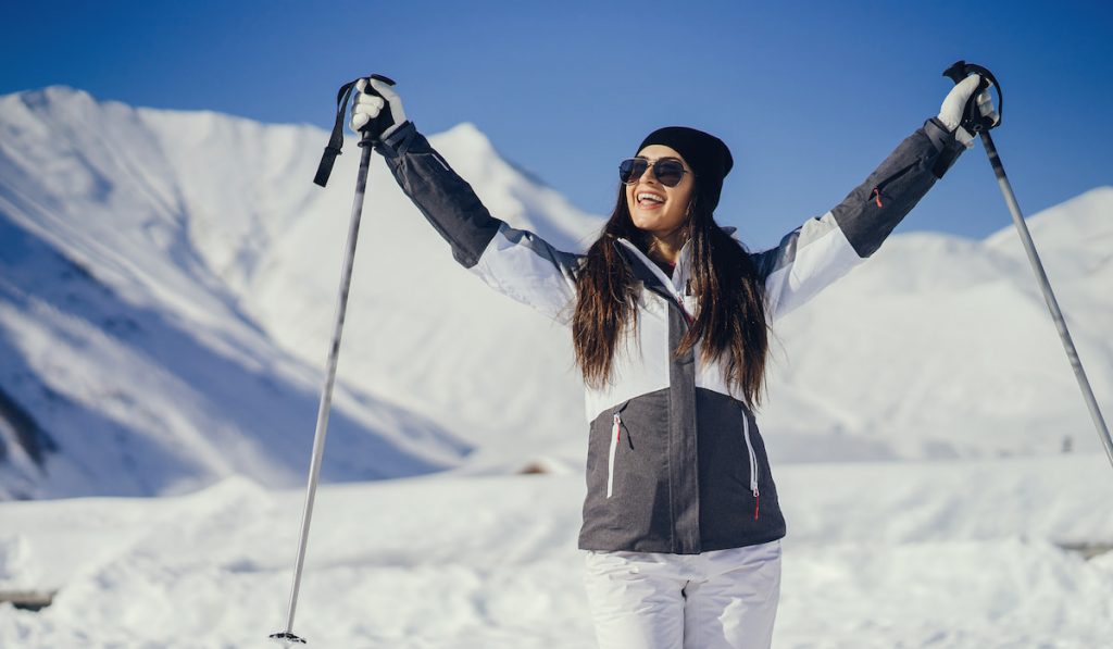 happy girl ready to skii at frozen lake 
