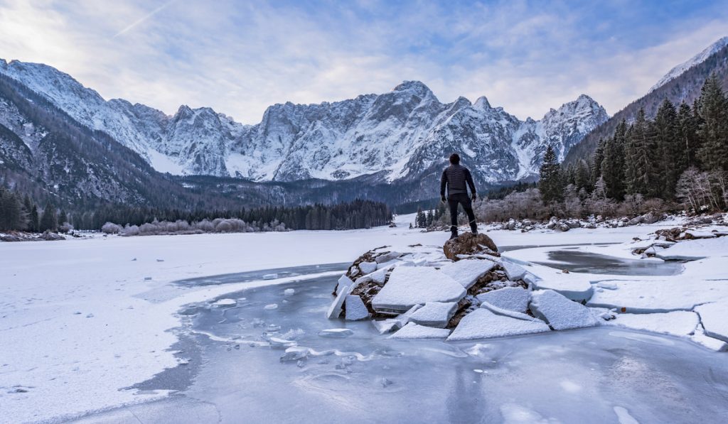 man standing on frozen lake louise