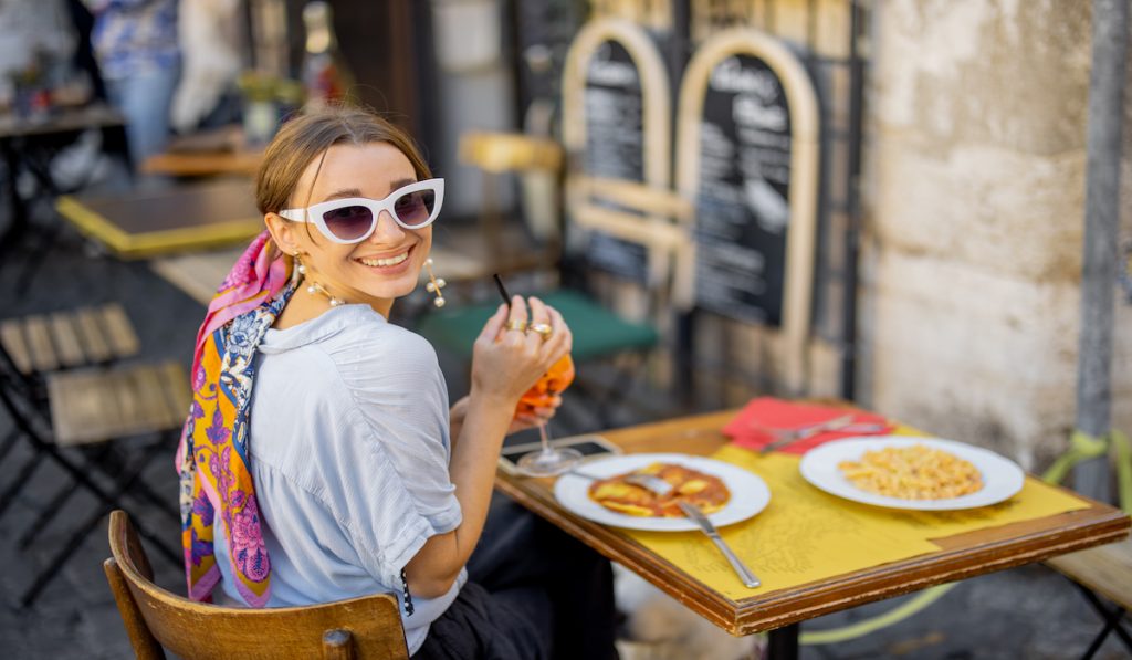 woman eating in a restaurant in italy 