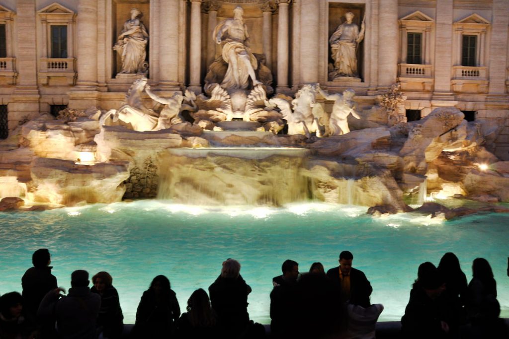  Tourists visiting the Trevi fountain (Fontana di Trevi), one of the major tourist attraction of Rome, Italy